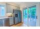 Contemporary kitchen featuring stainless steel appliances, sleek countertops, and outdoor views at 729 Lorentello Cir, Hillsborough, NC 27278