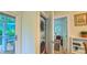 Modern laundry room with stacked washer and dryer, adjacent to a deck and bedroom at 729 Lorentello Cir, Hillsborough, NC 27278