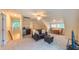Bright living room features plush seating, wet bar, and stylish ceiling fan at 729 Lorentello Cir, Hillsborough, NC 27278