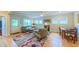 Cozy living room with a fireplace, hardwood floors, and a view of the dining area at 729 Lorentello Cir, Hillsborough, NC 27278
