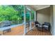 Relaxing screened porch features an outdoor grill and a comfortable seating area surrounded by lush greenery at 729 Lorentello Cir, Hillsborough, NC 27278