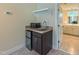 Stylish wet bar area with sleek sink, microwave, and mini fridge at 729 Lorentello Cir, Hillsborough, NC 27278