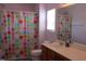 The bright bathroom features a colorful shower curtain and a vanity with ample counter space for all your essentials at 740 Obsidian Way, Durham, NC 27703