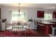 Bright dining area with a glass table, stylish chairs, and a red rug at 740 Obsidian Way, Durham, NC 27703