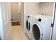 Convenient laundry room with a modern washer and dryer unit and ample storage at 740 Obsidian Way, Durham, NC 27703