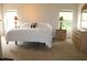 The spacious main bedroom features neutral walls, carpet, two windows for natural light and furniture at 740 Obsidian Way, Durham, NC 27703