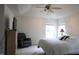 This primary suite offers ample space, a ceiling fan, TV, and a cozy recliner for ultimate comfort and relaxation at 740 Obsidian Way, Durham, NC 27703