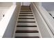 Clean staircase with white risers and dark wood treads and railing at 740 Obsidian Way, Durham, NC 27703