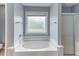 Bathroom with a large soaking tub and glass-enclosed shower at 75 Mountainside Ln, Sanford, NC 27332