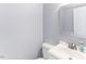 Half bathroom featuring a stylish framed mirror, vanity, and toilet at 75 Mountainside Ln, Sanford, NC 27332