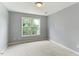 Carpeted bedroom with neutral paint and a bright window at 75 Mountainside Ln, Sanford, NC 27332