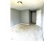A light grey painted bedroom featuring neutral carpet, white trim, and a closet at 75 Mountainside Ln, Sanford, NC 27332