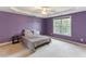 Spacious bedroom with tray ceiling, plush carpet, and a large window for natural light at 75 Mountainside Ln, Sanford, NC 27332