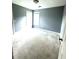 A bright bedroom with neutral carpet and paint, and two large windows at 75 Mountainside Ln, Sanford, NC 27332