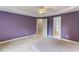 Large bedroom with carpet, neutral walls, with open doorways to bathroom and closet at 75 Mountainside Ln, Sanford, NC 27332