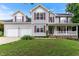 Charming two-story home with a well-manicured lawn, a two-car garage, and a welcoming front porch at 75 Mountainside Ln, Sanford, NC 27332