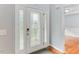 Elegant front door with decorative glass and side panels, leading into the foyer with hardwood floors at 75 Mountainside Ln, Sanford, NC 27332