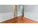 Hallway features hardwood floors, white walls, and doors to the various rooms at 75 Mountainside Ln, Sanford, NC 27332