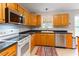 Bright kitchen with lots of light wood cabinets, stainless steel appliances, and dark countertops at 75 Mountainside Ln, Sanford, NC 27332