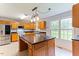 Traditional kitchen features light wood cabinets, stainless steel appliances, and large island at 75 Mountainside Ln, Sanford, NC 27332