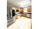 Features a tiled floor, stainless steel appliances, and oak colored cabinetry at 75 Mountainside Ln, Sanford, NC 27332