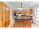 Spacious kitchen features light wood cabinets, stainless steel refrigerator, and large center island at 75 Mountainside Ln, Sanford, NC 27332