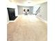 Spacious living room with a fireplace, stairs, and large windows that provide lots of natural light at 75 Mountainside Ln, Sanford, NC 27332