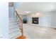 Living room with a fireplace, a staircase with wood and wrought iron details, and hardwood floors at 75 Mountainside Ln, Sanford, NC 27332
