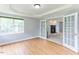 Bright living room features hardwood floors, large windows, and glass doors to the next room with fireplace at 75 Mountainside Ln, Sanford, NC 27332