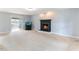 Living room with a fireplace, an adjacent sunroom with french doors and an aquarium at 75 Mountainside Ln, Sanford, NC 27332