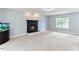 Spacious living room with a fireplace and a large window overlooking the backyard at 75 Mountainside Ln, Sanford, NC 27332