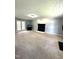 Large living room featuring a fireplace and glass paneled doors leading to the sun room at 75 Mountainside Ln, Sanford, NC 27332