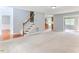 Spacious living room featuring a fireplace, a staircase, and views of the adjacent dining room and kitchen at 75 Mountainside Ln, Sanford, NC 27332