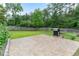 Grilling patio in a secluded backyard with mature trees and lush green grass at 75 Mountainside Ln, Sanford, NC 27332