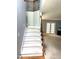Carpeted staircase with decorative iron railing leading to the upper level at 75 Mountainside Ln, Sanford, NC 27332
