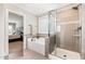 Elegant bathroom features a soaking tub with tiled surround and a glass-enclosed shower at 808 Buckner Ct, Fuquay Varina, NC 27526