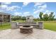 Inviting backyard fire pit with stone surround and bench seating at 808 Buckner Ct, Fuquay Varina, NC 27526