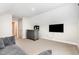 Cozy living room featuring a wet bar and mounted TV for entertainment at 808 Buckner Ct, Fuquay Varina, NC 27526