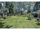 Expansive backyard featuring lush lawn, mature trees, and a charming gazebo perfect for outdoor relaxation at 8156 Nc 42 Hwy W, Kenly, NC 27542