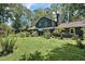 A beautiful backyard view showcasing the home's exterior, patio, and lush green lawn at 8156 Nc 42 Hwy W, Kenly, NC 27542