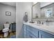 Bright bathroom boasts a vanity, toilet, mirror, and decor; ideal for relaxation and functionality at 8156 Nc 42 Hwy W, Kenly, NC 27542