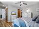 Cozy bedroom offers an updated ceiling fan and wood flooring, with a tv and closet nearby at 8156 Nc 42 Hwy W, Kenly, NC 27542