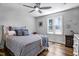 Light, airy bedroom features hardwood flooring, updated ceiling fan, and large picture window at 8156 Nc 42 Hwy W, Kenly, NC 27542
