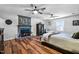 Spacious bedroom features wood floors, fireplace, ceiling fans, and closet for a warm and inviting space at 8156 Nc 42 Hwy W, Kenly, NC 27542