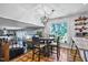 Cozy dining area with a stylish table, four chairs, modern lighting, and a large window offering a view of the trees at 8156 Nc 42 Hwy W, Kenly, NC 27542