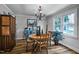 Cozy dining room with wood floors, large window, and unique chandelier at 8156 Nc 42 Hwy W, Kenly, NC 27542