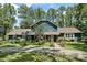 Inviting two-story home with beautiful landscaping, a charming front porch, and a long driveway lined by mature trees at 8156 Nc 42 Hwy W, Kenly, NC 27542
