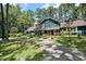 Charming two-story home with beautiful landscaping, a welcoming front porch, and long driveway lined by mature trees at 8156 Nc 42 Hwy W, Kenly, NC 27542