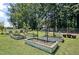 Charming garden with raised beds and trellises, perfect for cultivating plants and vegetables at 8156 Nc 42 Hwy W, Kenly, NC 27542