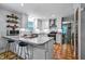 Bright kitchen features white cabinets, granite countertops, stainless steel appliances, and an island with bar seating at 8156 Nc 42 Hwy W, Kenly, NC 27542